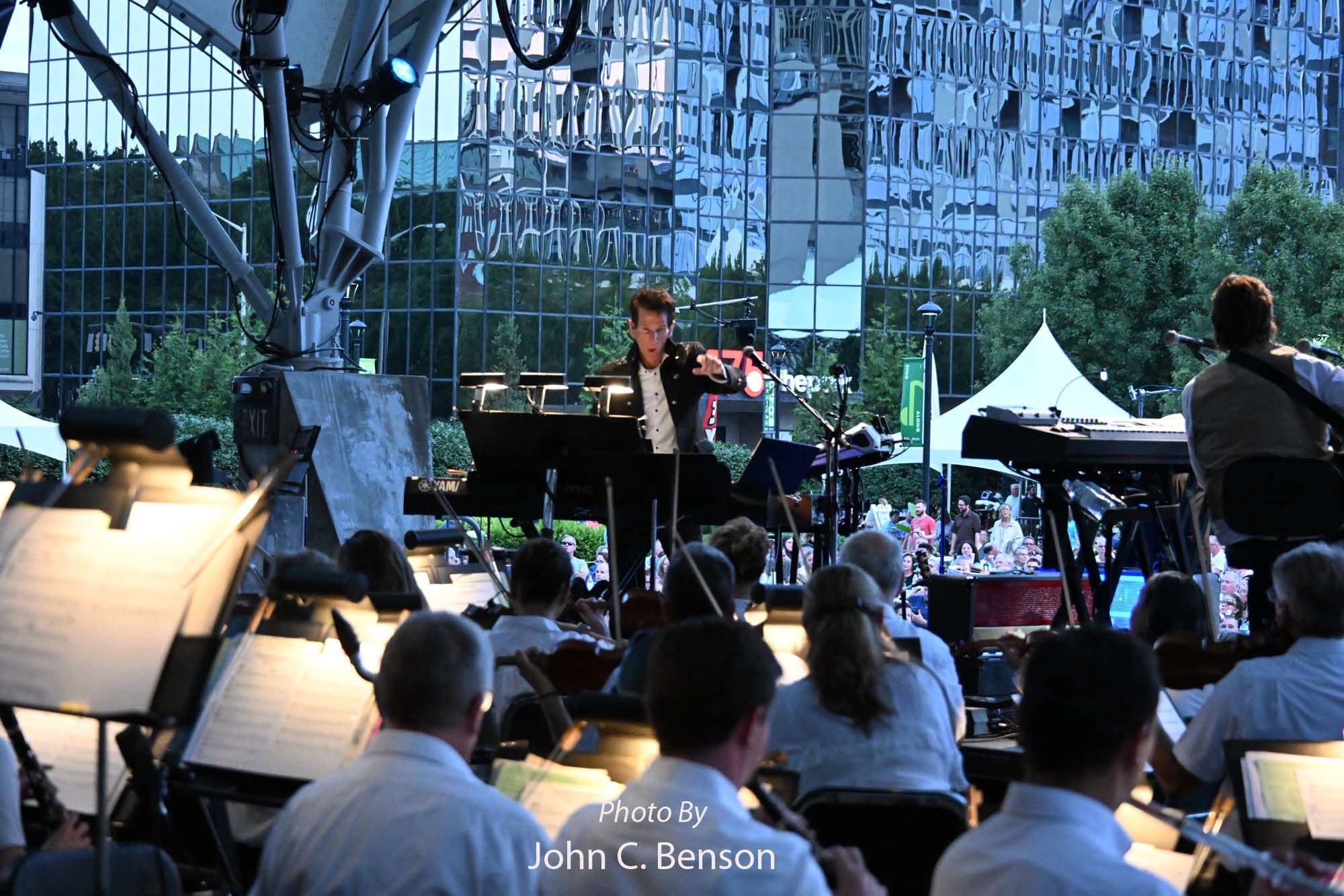 Tom Brooks giving the downbeat from the piano, strings in the foreground